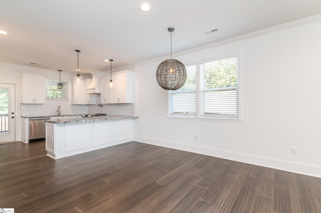 kitchen featuring appliances with stainless steel finishes, a healthy amount of sunlight, and white cabinetry