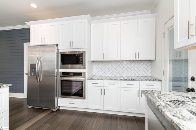 kitchen with crown molding, white cabinetry, dark hardwood / wood-style flooring, and stainless steel appliances