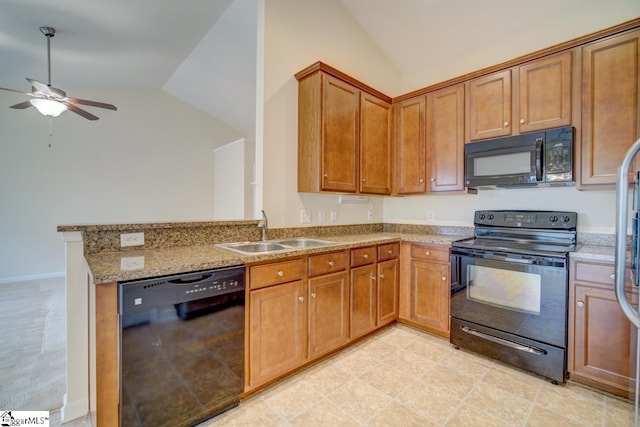 kitchen featuring light stone counters, sink, kitchen peninsula, black appliances, and ceiling fan