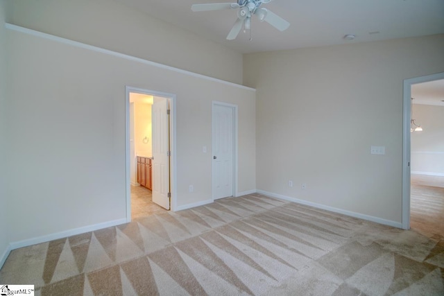 unfurnished bedroom with ceiling fan, light colored carpet, and a closet