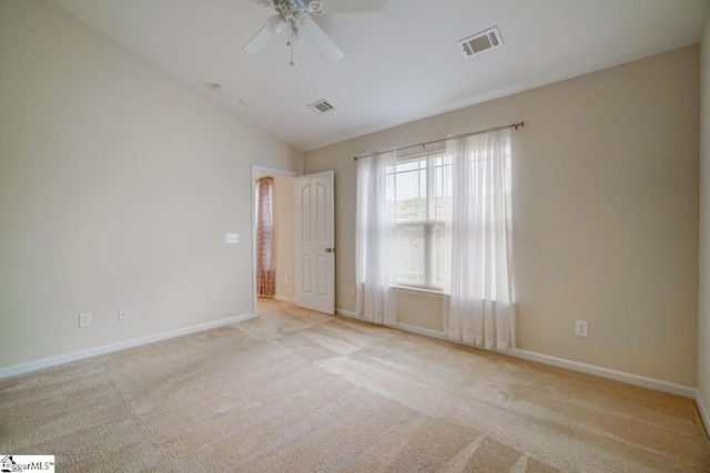 carpeted empty room with ceiling fan and vaulted ceiling