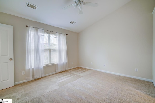 unfurnished room with ceiling fan, light carpet, and vaulted ceiling