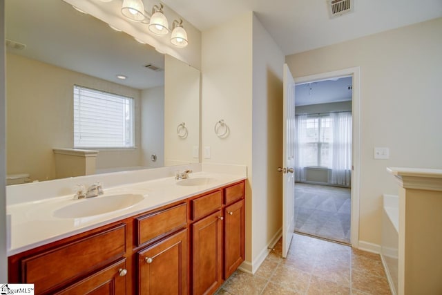 bathroom featuring vanity, toilet, and tile patterned floors