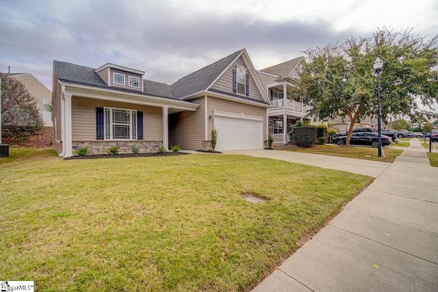 view of front of home featuring a garage, covered porch, and a front yard