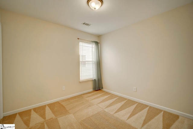 unfurnished room featuring light colored carpet