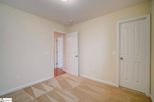 unfurnished bedroom featuring light colored carpet