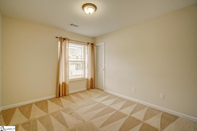 empty room featuring light colored carpet