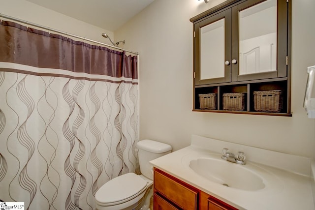 bathroom featuring vanity, toilet, and curtained shower