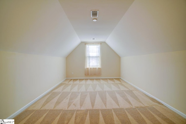 additional living space with light carpet and lofted ceiling