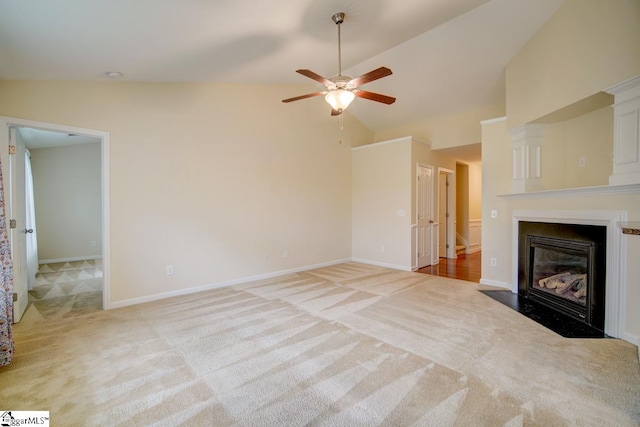 unfurnished living room with ceiling fan, lofted ceiling, and light carpet