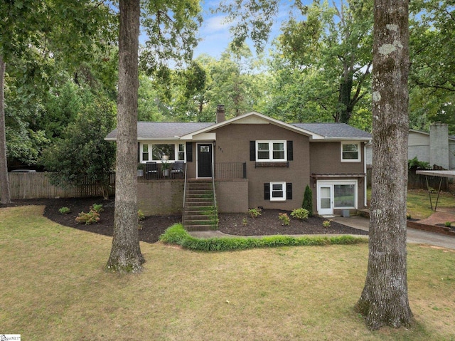 view of front of property with a wooden deck and a front yard