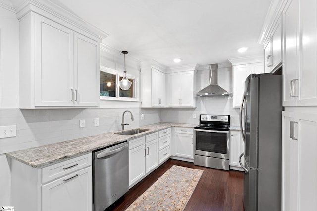 kitchen featuring dark wood-type flooring, sink, white cabinetry, wall chimney range hood, and appliances with stainless steel finishes