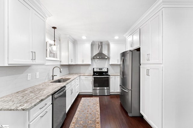 kitchen with light stone counters, white cabinets, wall chimney exhaust hood, dark wood-type flooring, and stainless steel appliances