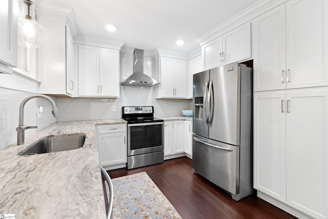 kitchen with white cabinets, sink, dark wood-type flooring, wall chimney range hood, and appliances with stainless steel finishes