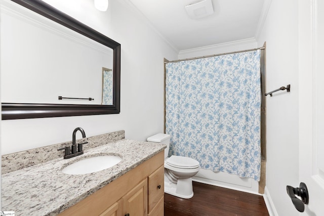 full bathroom featuring vanity, shower / bath combo, hardwood / wood-style flooring, ornamental molding, and toilet