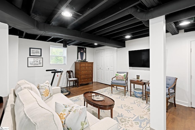 living room featuring hardwood / wood-style floors and beamed ceiling