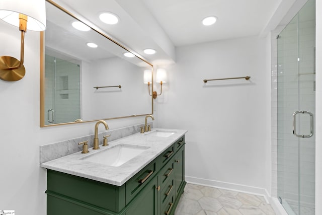 bathroom featuring vanity, a shower with shower door, and tile patterned floors