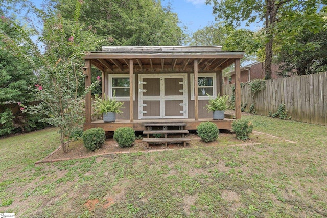 view of outbuilding with a yard