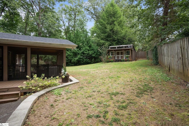 view of yard featuring a storage shed and a wooden deck