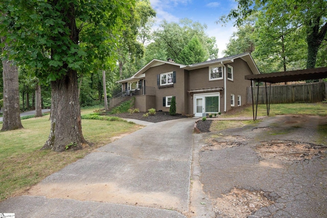 view of front of house with a front yard and a carport