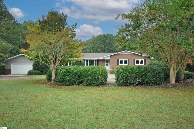 single story home featuring a front lawn and a garage