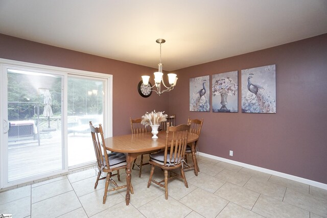 dining room featuring a notable chandelier and light tile patterned flooring