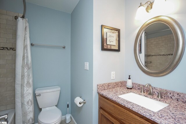 full bathroom with vanity, shower / bath combo with shower curtain, and toilet