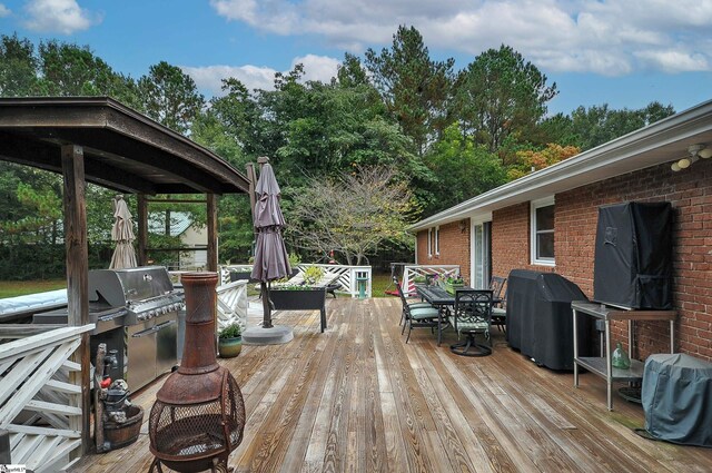 wooden terrace with a gazebo and grilling area