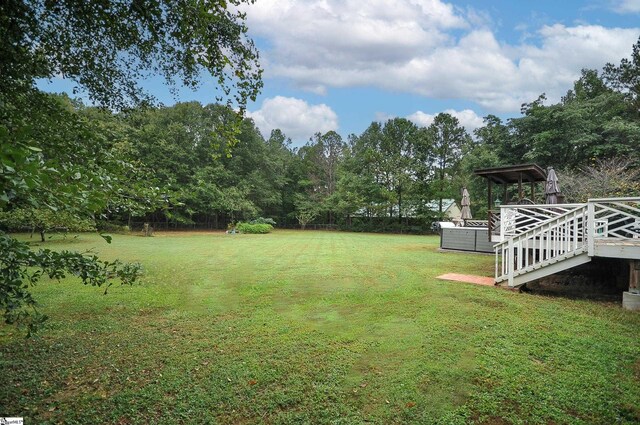 view of yard featuring a wooden deck