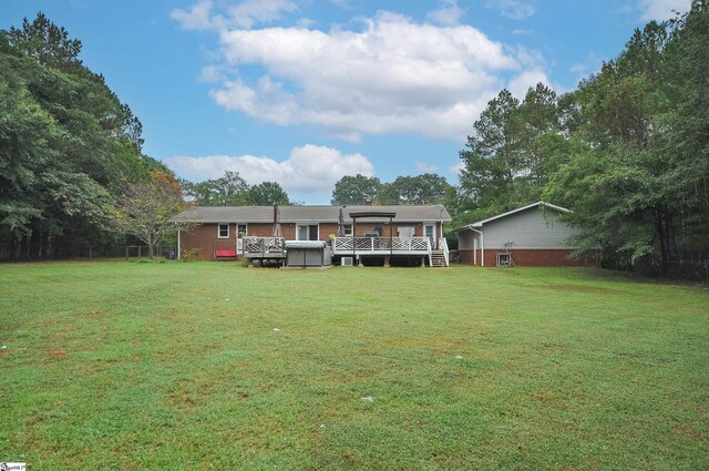 back of house featuring a yard and a deck