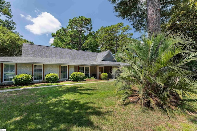 ranch-style home with a front lawn