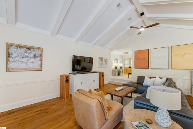 living room with ceiling fan, lofted ceiling with beams, and light hardwood / wood-style floors