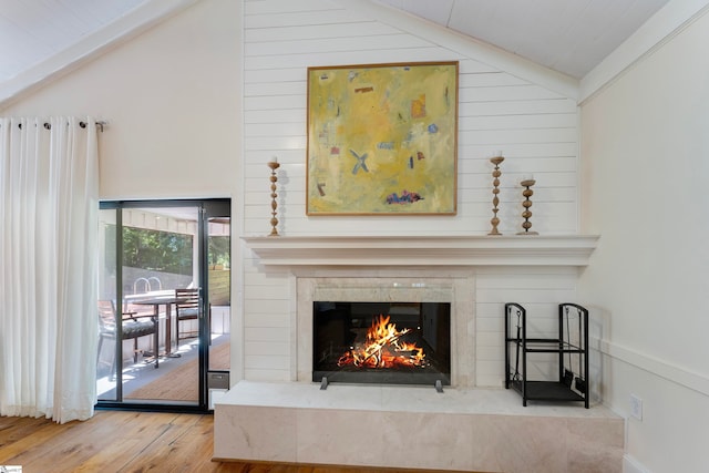 room details featuring a high end fireplace, wood walls, hardwood / wood-style floors, and wood ceiling