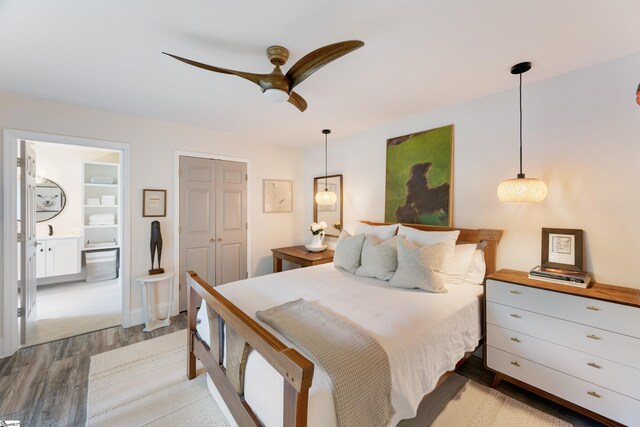 bedroom featuring ceiling fan, light wood-type flooring, connected bathroom, and a closet