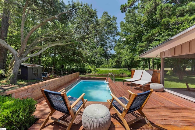 view of swimming pool featuring a shed and a deck