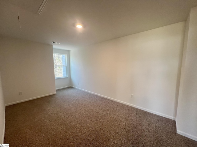 empty room with dark carpet