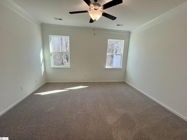 carpeted empty room featuring ceiling fan and crown molding