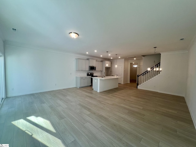 unfurnished living room with a notable chandelier, sink, ornamental molding, and light hardwood / wood-style floors