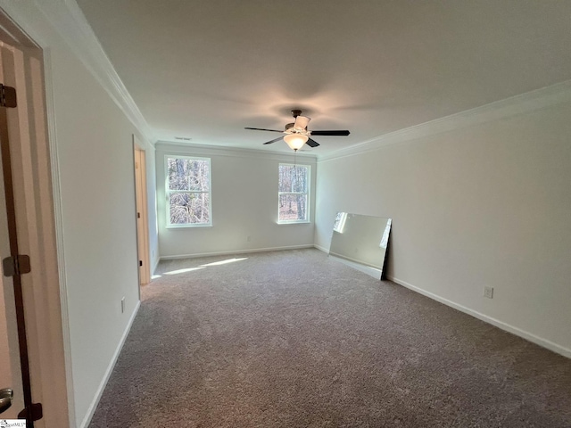 spare room with ceiling fan, crown molding, and carpet flooring