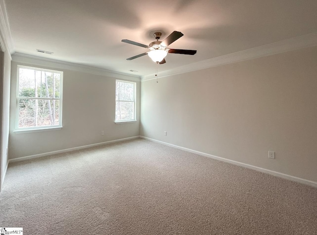 carpeted spare room featuring ornamental molding and ceiling fan