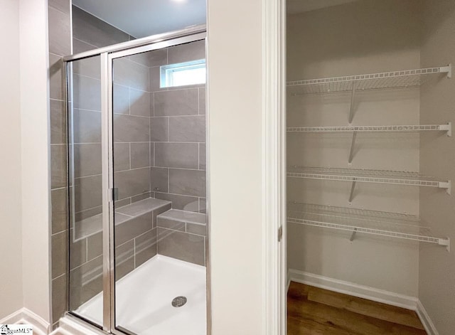 bathroom featuring hardwood / wood-style flooring and an enclosed shower