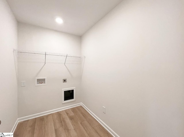 laundry room with electric dryer hookup, washer hookup, and wood-type flooring