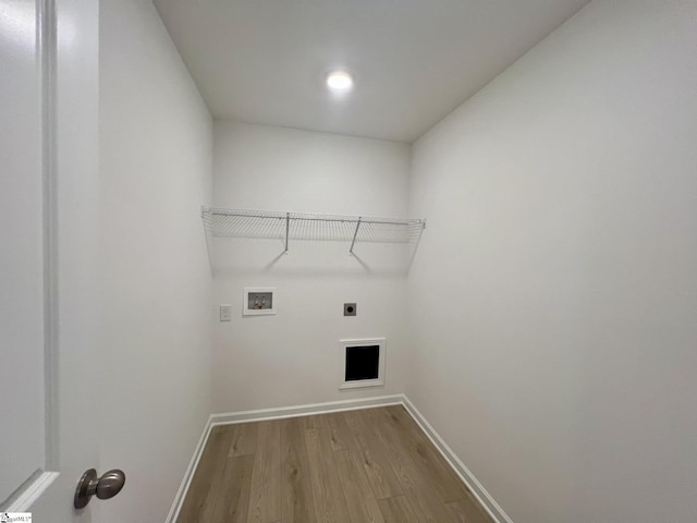 laundry room with light hardwood / wood-style floors, washer hookup, and electric dryer hookup