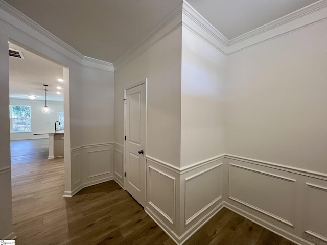 hall with sink, ornamental molding, and dark hardwood / wood-style floors