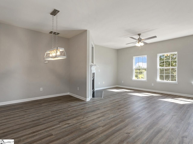 unfurnished living room with ceiling fan and dark hardwood / wood-style floors