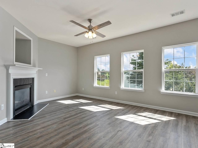 unfurnished living room with ceiling fan and dark hardwood / wood-style floors