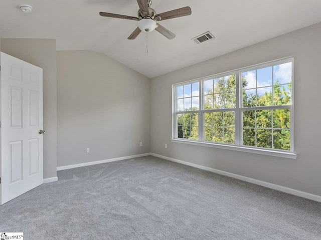 carpeted spare room with ceiling fan and lofted ceiling