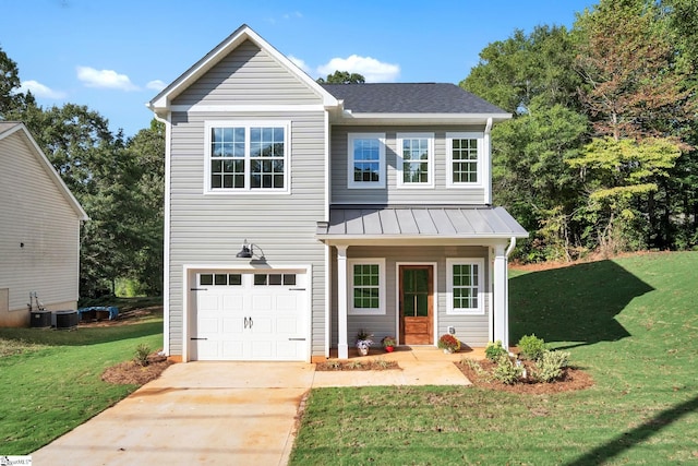 view of property with a front lawn and a garage