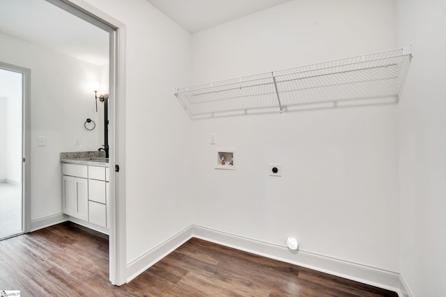 laundry area featuring electric dryer hookup, hookup for a washing machine, hardwood / wood-style floors, and sink