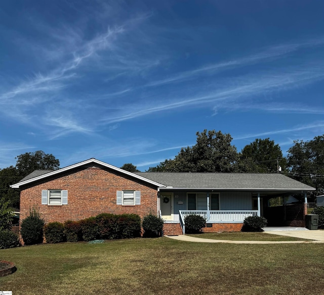 ranch-style house with a porch, a front yard, and a carport